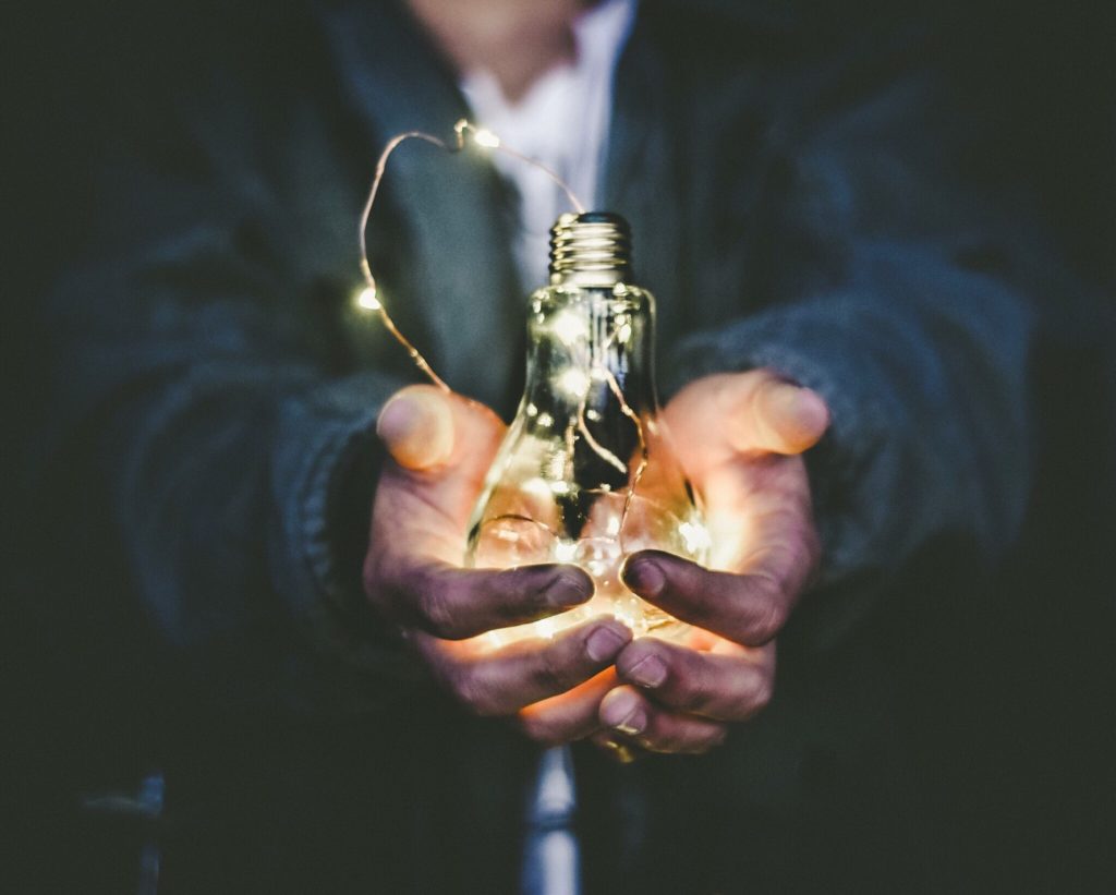 Leadership Development means the ability to embrace change - man holding lightbulb