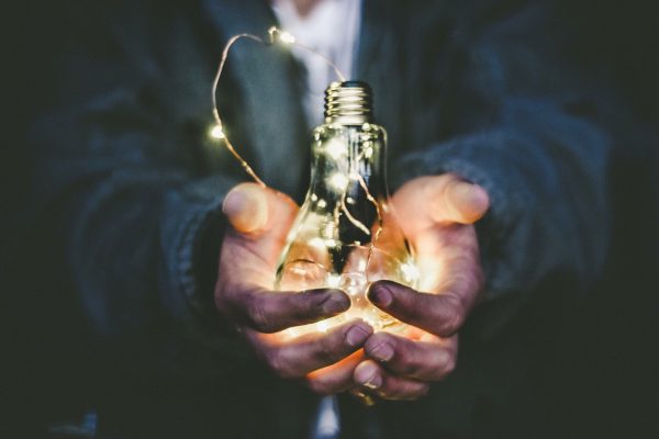 Leadership Development means the ability to embrace change - man holding lightbulb